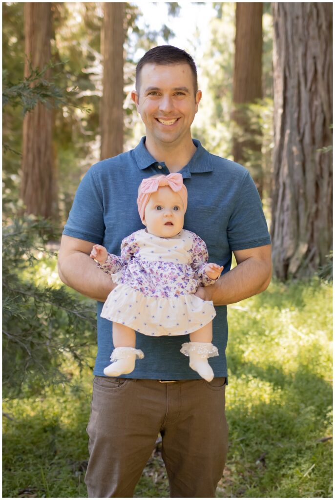 Tom holding baby Olivia in Cedarpines Park