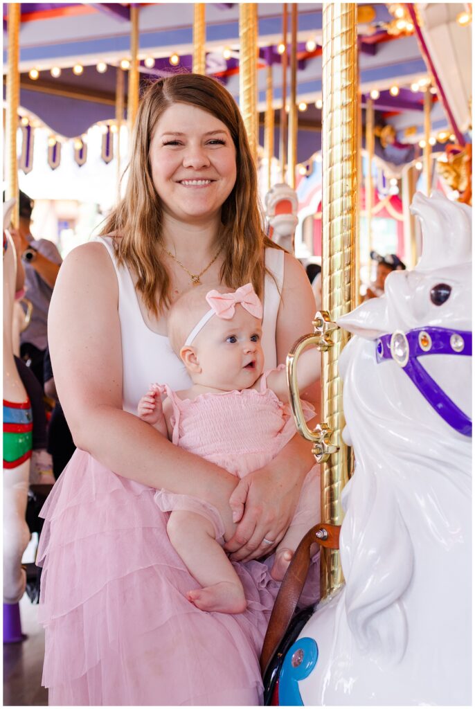 Child and mom riding a horse on the King Arthur Carrousel in Fantasyland