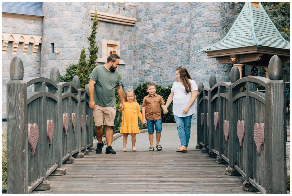 Family crossing the bridge at Snow White's Wishing Well